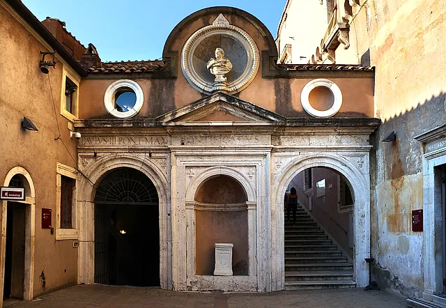 The Cortile dell'Angelo inside the castle: the small Renaissance chapel front of Saints Cosmas and Damian with a marble bust in a round niche, two round windows and a stone staircase beside it